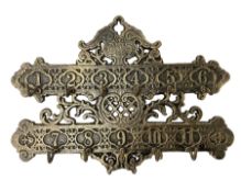 Bronzed cast metal numbered key rack of pierced and scrolled design