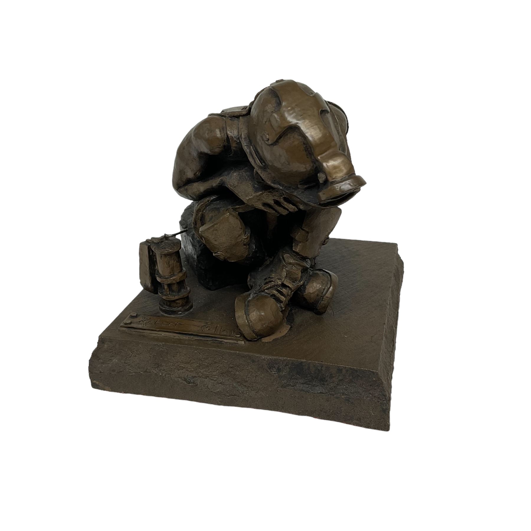 Bronzed cold cast figure of a miner sat beside a lamp by Robert Olley on rocky square plinth base