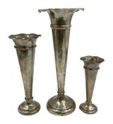 Three hallmarked silver trumpet vases with frilled rims and weighted bases