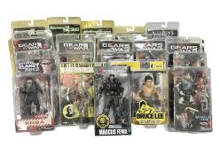 Sixteen carded action figures comprising seven 'Gears of War'; four 'Hitchhikers Guide to the Galaxy