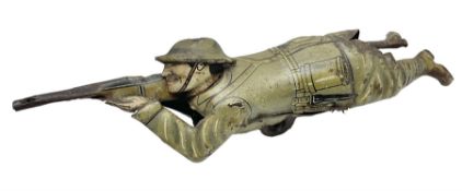 Einfalt (Germany) lithographed tin-plate clockwork figure of a soldier depicted lying on the ground