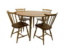 Ercol - circular drop leaf table on splayed tapering supports; together with four dining chairs