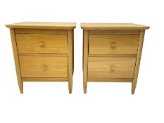 Pair light oak two drawer bedside chests