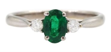 18ct white gold three stone oval emerald and round brilliant cut diamond ring