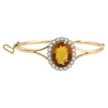 Early 20th century 15ct rose gold oval citrine and milgrain set old cut diamond hinged bangle