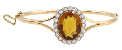 Early 20th century 15ct rose gold oval citrine and milgrain set old cut diamond hinged bangle