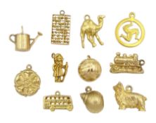 Nine 9ct gold pendant/charms including wizard