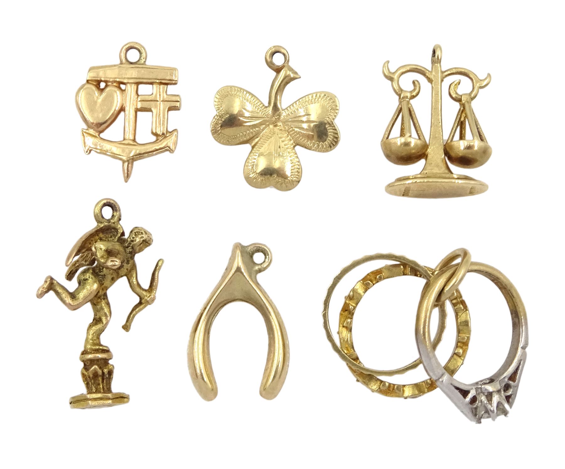 Six 9ct gold pendant/charms including cupid