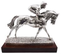 Modern silver model of a racehorse with mounted jockey