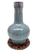 Blue glazed vase of squat baluster form with elongated neck