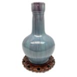 Blue glazed vase of squat baluster form with elongated neck
