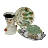 Chelsea style dish moulded as a large flower head with green stalk handle and two leaves with red an