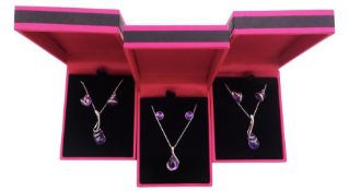 Three pairs of silver amethyst stud earrings and a matching pendant necklaces