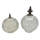 Two clear glass light shades of globular form with foliate metal mounts