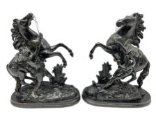 Pair of spelter figural statues of man and rearing horse