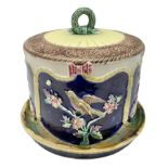 Majolica cheese dome and cover decorated with birds amongst foliage in relief on a blue ground
