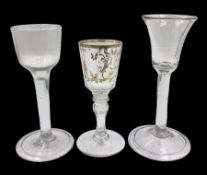 Three 18th century wine glasses comprising a plain stemmed glass with bell shaped bowl and conical f