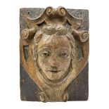 19th/20th century oak ecclesiastical wall plaque carved in relief depicting a portrait within a scro