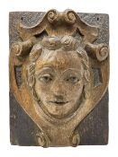 19th/20th century oak ecclesiastical wall plaque carved in relief depicting a portrait within a scro