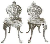 Pair of Victorian white painted cast iron garden chairs