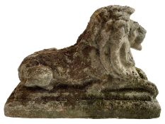 Weathered cast stone recumbent lion