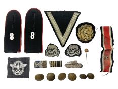 Collection of eleven German metal and cloth badges and uniform buttons including driver's badge