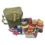 Quantity of modern medal ribbons in various length rolls and strips; and WW2 gas mask case dated 194