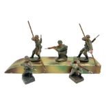 German Elastolin camouflaged wooden boat with two soldier paddlers L24cm; together with three simila