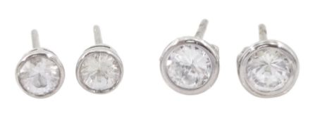 Pair of 9ct white gold white sapphire stud earrings and a similar pair of 9ct white gold cubic zirco