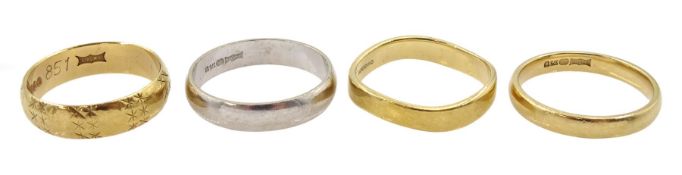 Three yellow gold wedding bands and a white gold wedding band