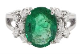 18ct white gold oval cut emerald and round brilliant cut diamond ring