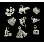 Nine silver charms including a dog in a kennel