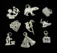 Nine silver charms including a dog in a kennel