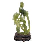 Carved jade figure of a phoenix perched on a flowering branch