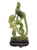 Carved jade figure of a phoenix perched on a flowering branch