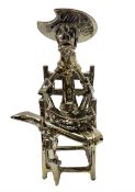 Large gold lustre figure of Don Quixote sat upon a chair reading a book