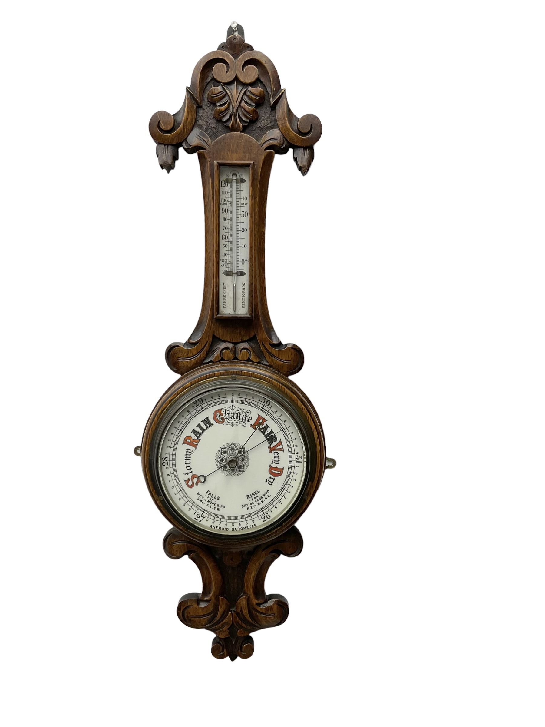 English - Edwardian aneroid barometer in a carved scroll work oak case