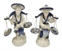Pair of blue and white fisherman figures