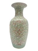 Large Chinese vase of baluster form with foliate decoration upon a white ground