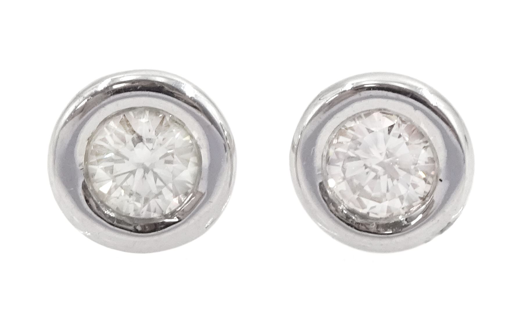 Pair of 14ct white gold bezel set round brilliant cut diamond stud earrings