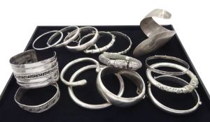 Collection of twelve silver bangles and two white metal bangles