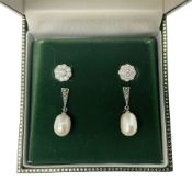Pair of silver cubic zirconia flower cluster stud earrings and a pair of silver marcasite and pearl