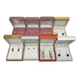 Eight pairs of silver stone set earrings