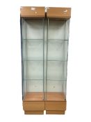 Pair light oak and glass open single display cabinets