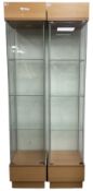 Pair light oak and glass single display cabinets