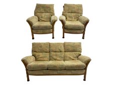 Mid-20th century beech framed three seat sofa (W1180cm) and pair of matching armchairs (W95cm) uphol