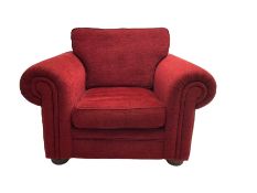 Traditional armchair upholstered in textured red fabric with matching cushions