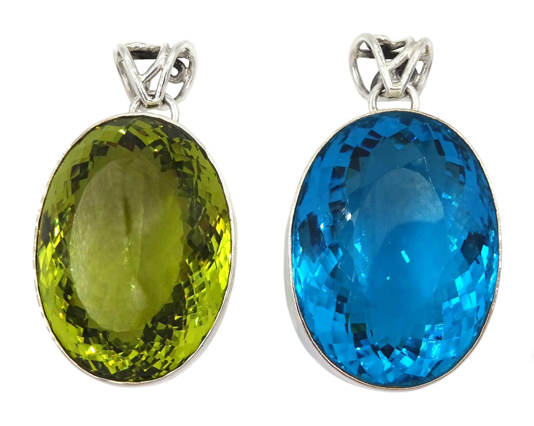 Two large silver green and blue stone set pendants