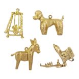 Four 9ct gold pendant/charms including articulated child on a swing