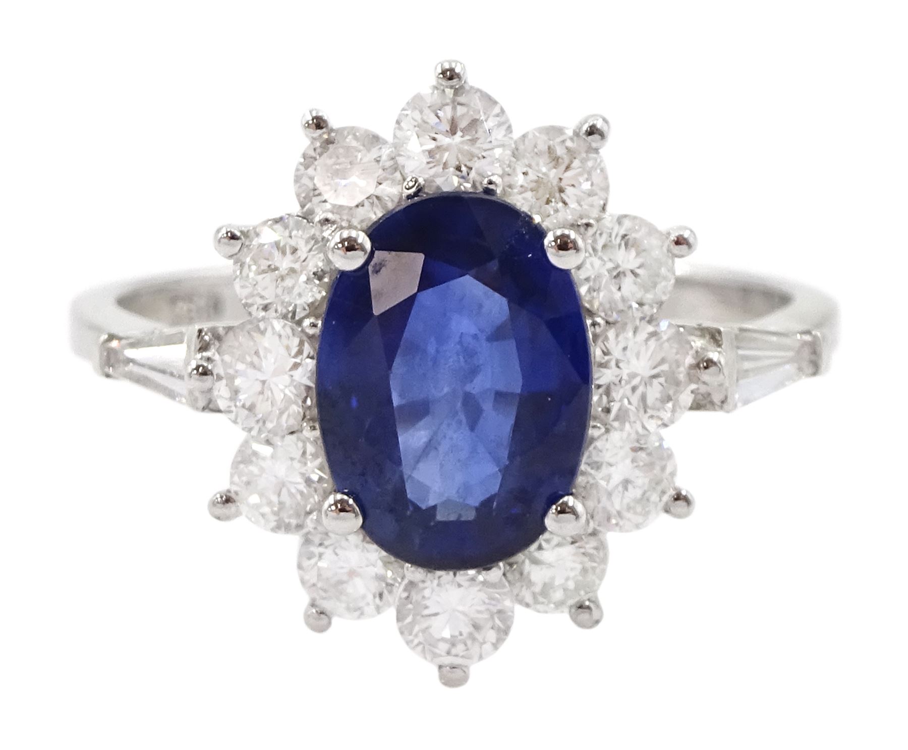 18ct white gold oval sapphire and round brilliant cut diamond cluster ring